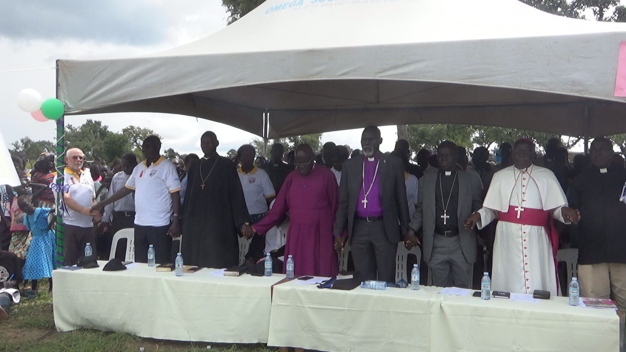 Members of ARLPI joining hands in prayers together with members of South Sudan Council of Churches during prayers In Paluda Refugee settlement.